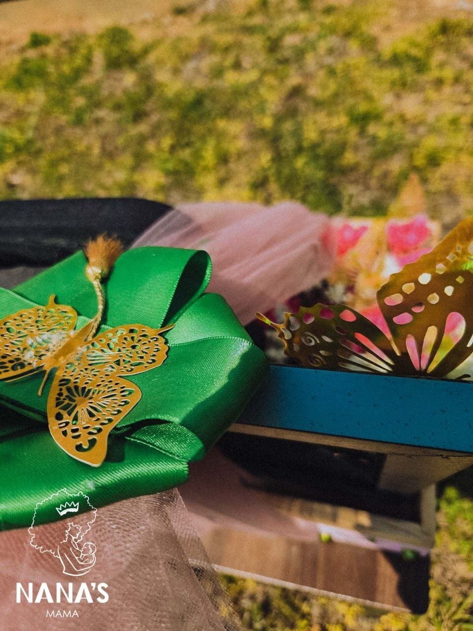 Green bow and gold butterfly packaging detail